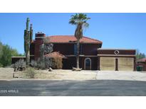 Two-story home features a red tile roof, desert landscaping, and a palm tree in the front yard at 5716 E Desert Vista Trl, Cave Creek, AZ 85331