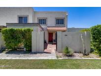 Charming two-story home with a red tile entry, desert landscaping, and an enclosed front yard at 7808 E Valley Vista Dr, Scottsdale, AZ 85250