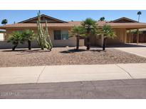 Charming single-story home with desert landscaping, palm trees, and convenient carport at 8318 E Via De Los Libros --, Scottsdale, AZ 85258