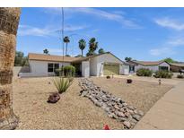 Charming single-story home featuring desert landscaping, a two-car garage, and a well-maintained exterior at 9330 E Kalil Dr, Scottsdale, AZ 85260