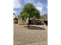 Cozy single-story home with xeriscaped front yard, mature shade tree, and colorful flowering bush at 9438 N 5Th Ave, Phoenix, AZ 85021