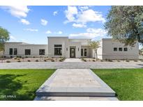 Stunning exterior elevation showcasing a modern home with clean lines and meticulous landscaping at 9611 E Clinton St, Scottsdale, AZ 85260