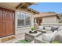 Inviting front porch with outdoor seating area and a decorative welcome mat near the front door at 10015 E Mountain View Rd # 2034, Scottsdale, AZ 85258