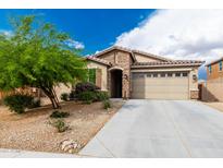 Charming home featuring stone accents, a well-maintained yard, and a two-car garage at 10849 S 175Th Dr, Goodyear, AZ 85338