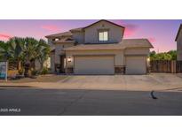 Charming two-story home with three-car garage, tile roof, and desert landscaping at 11003 E Ravenna Cir, Mesa, AZ 85212