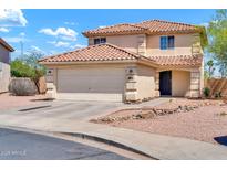 Attractive two-story house with a tiled roof, two-car garage, and a well-maintained desert landscape at 12709 N El Frio St, El Mirage, AZ 85335