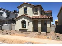Charming two-story home featuring a red tile roof, stucco siding, and a welcoming front porch at 13481 N 158Th Ave, Surprise, AZ 85379