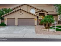 Charming home featuring a three-car garage, desert landscaping, and an arched entryway at 15237 S 19Th Way, Phoenix, AZ 85048