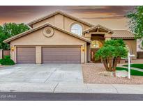 Charming home featuring a desert landscaped front yard, large garage, and covered entryway at 15237 S 19Th Way, Phoenix, AZ 85048