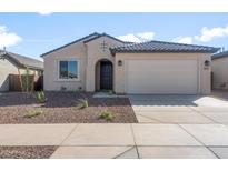 Charming single-story home with a well-maintained yard and a two-car garage in a residential neighborhood at 16689 W Whispering Wind Dr, Surprise, AZ 85387