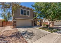 Two-story home with neutral stucco, stone accents and a 2 car garage at 17235 W Statler St, Surprise, AZ 85388