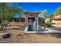 Inviting clubhouse entrance featuring a stone facade and a tranquil water fountain feature at 20100 N 78Th Pl # 1048, Scottsdale, AZ 85255