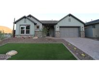 Charming single-story home with well-manicured lawn and stone accents at 32541 N 135Th Dr, Peoria, AZ 85383