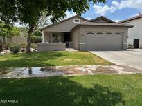 Charming single-story home featuring a well-maintained lawn and attached two-car garage at 3677 E Park Ave, Gilbert, AZ 85234