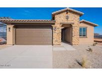 Inviting home featuring a two-car garage and stone facade at 39980 W Bunker Dr, Maricopa, AZ 85138
