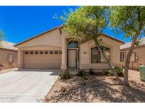 Charming single-story home featuring desert landscaping, a two-car garage, and a welcoming front entrance at 40329 W Thornberry Ln, Maricopa, AZ 85138