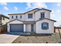 Charming two-story home featuring a gray two-car garage and well-maintained landscaping at 5881 N 193Rd Dr, Litchfield Park, AZ 85340