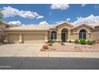 Inviting single-story home with a well-manicured front yard and three-car garage at 6388 W Donald Dr, Glendale, AZ 85310