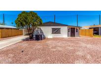 Charming home featuring a low maintenance yard, complemented by desert landscaping and mature shade tree at 7442 E Baseline Rd, Mesa, AZ 85209
