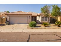 Cozy single-Gathering home showcasing a well maintained front yard and a spacious two-car garage at 8952 W Monte Vista Rd, Phoenix, AZ 85037