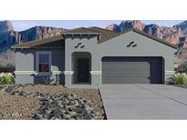 Inviting single-story home featuring a gray exterior, neutral trim, desert landscaping, and a two-car garage at 9943 S Desert View Dr, Apache Junction, AZ 85120