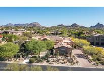 Stunning view of a desert home showcasing clay tile roof and beautiful desert landscaping at 10531 E Cinder Cone Trl, Scottsdale, AZ 85262