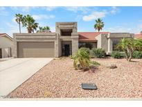 Charming single-story home featuring a low-maintenance desert landscape and a welcoming two-car garage at 11106 E Clinton St, Scottsdale, AZ 85259