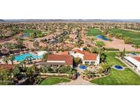 Aerial view of a club house, pools, putting greens and a well-maintained golf course within a beautiful community at 12937 W El Sueno Ct, Sun City West, AZ 85375