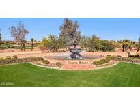 Stunning community fountain with lush landscaping and mature trees on the Corte Bella golf course in Sun City West, Arizona at 12937 W El Sueno Ct, Sun City West, AZ 85375