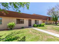 Traditional townhome featuring desert landscaping, a private entry, and a light-colored walkway at 1634 E Donner Dr, Tempe, AZ 85282