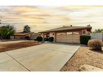 Charming single-story home showcasing a well-maintained front yard and two car garage at 18814 N 33Rd Ave, Phoenix, AZ 85027