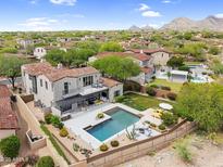 Panoramic aerial view of the property showcasing a sparkling pool, patio, and lush landscaping at 19829 N 97Th St, Scottsdale, AZ 85255