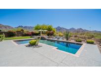 Stunning pool area with mountain views, comfortable seating, and lush desert landscaping at 19829 N 97Th St, Scottsdale, AZ 85255
