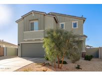 Charming two-story home boasts a neutral color palette, desert landscaping, and a welcoming two-car garage at 22962 N 182Nd Ln, Surprise, AZ 85387