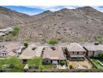 Beautiful aerial perspective reveals a home with a landscaped yard and mountain views in the distance at 29214 N 19Th Ln, Phoenix, AZ 85085