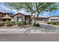 Charming single-Gathering home featuring stone accents, desert landscaping, and a welcoming two-car garage at 29214 N 19Th Ln, Phoenix, AZ 85085