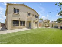 Spacious backyard featuring a well-maintained lawn and a charming patio, perfect for outdoor entertaining at 3349 E Flamingo Ct, Gilbert, AZ 85297