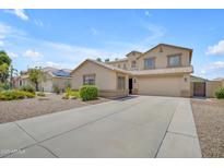 Inviting beige two-story home with a spacious driveway and desert landscaping at 3349 E Flamingo Ct, Gilbert, AZ 85297