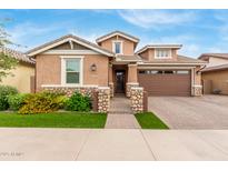 Charming two-story home featuring a stone facade, landscaped yard, and brick driveway for added curb appeal at 3637 E Ebano St, Gilbert, AZ 85295