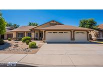Charming single-story home featuring a three-car garage, landscaped yard and neutral color palette at 4349 W Cielo Grande --, Glendale, AZ 85310