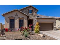 Charming single-story home with stone accents, desert landscaping, and a welcoming front porch at 6912 E Quill St, Mesa, AZ 85207