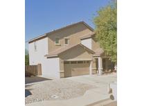 Charming two-story home featuring a tile roof, attached two-car garage, and low maintenance landscaping at 7090 S 252 Dr, Buckeye, AZ 85326