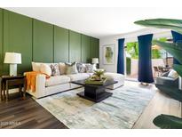 Stylish living room featuring a comfortable sectional sofa and access to a private outdoor patio at 7350 N Via Paseo Del Sur -- # P105, Scottsdale, AZ 85258