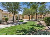Inviting front yard with mature trees and landscaping create an inviting entrance to the property at 7575 E Indian Bend Rd # 1137, Scottsdale, AZ 85250