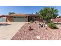 Charming single-story home featuring a well-maintained front yard, lush landscaping, and a welcoming exterior at 7608 W Mescal St, Peoria, AZ 85345