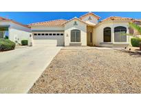 Charming single-story home with a two car garage and low maintenance desert landscaping at 8854 W Augusta Ave, Glendale, AZ 85305
