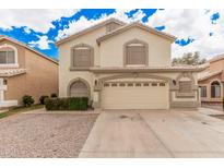 Two-story home with a neutral color scheme, two-car garage and arched windows at 917 N Blackbird Dr, Gilbert, AZ 85234
