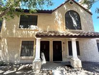 Charming two-story townhome featuring a tile roof, white columns, and inviting dual entrances at 921 W University Dr # 1038, Mesa, AZ 85201