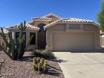 Charming single-story home featuring desert landscaping and a neutral color scheme at 9853 W Pontiac Dr, Peoria, AZ 85382