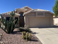 Charming single-story home featuring desert landscaping, neutral stucco, and a two-car garage at 9853 W Pontiac Dr, Peoria, AZ 85382
